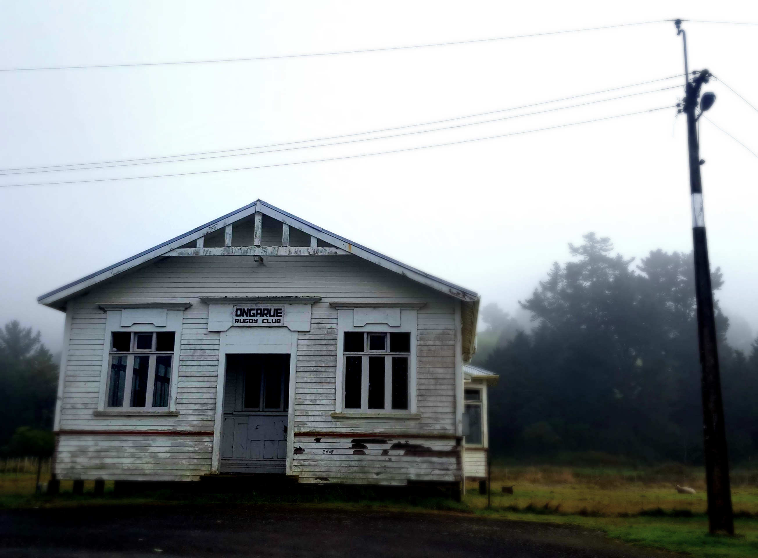 old rugby club building in the mist in a small village in rural new zealand