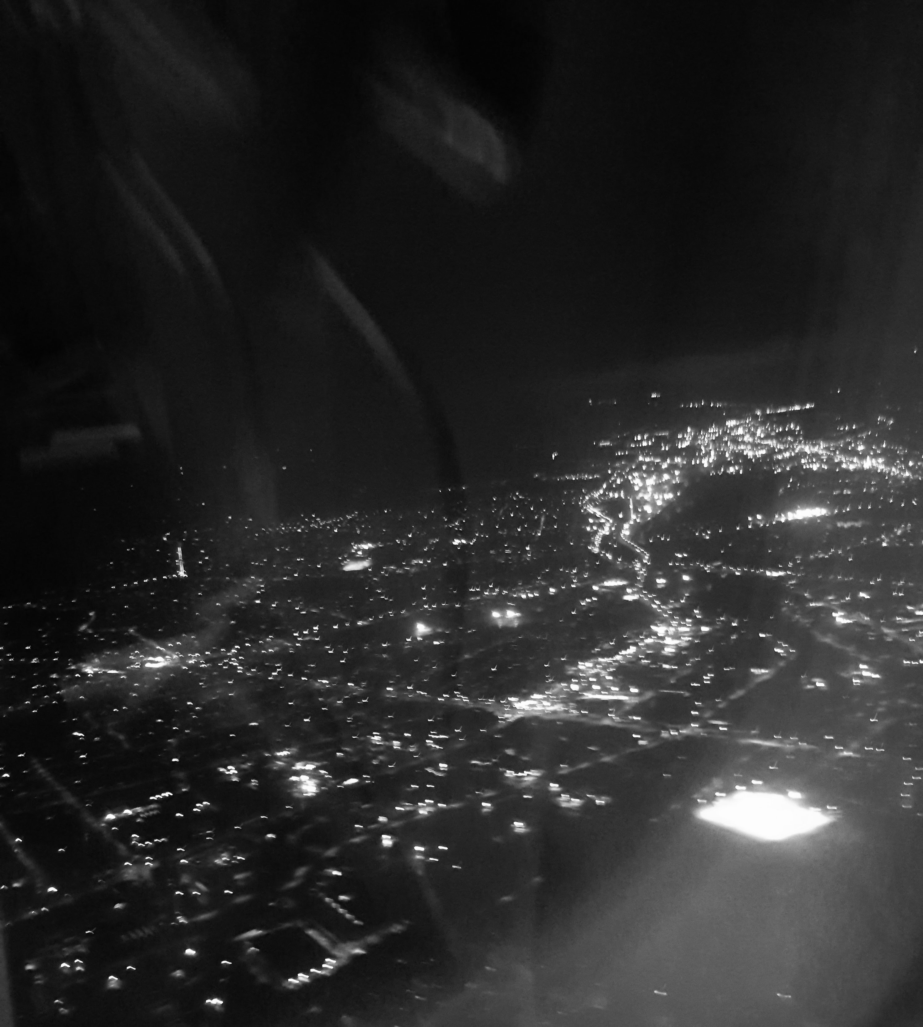 lights of a city seen from a plane. Black and white
